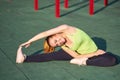 Happy young woman stretching before running outdoors in workout sports ground Royalty Free Stock Photo