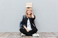 Happy young woman student holding books on head. Royalty Free Stock Photo