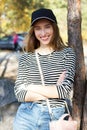 Happy young woman in a stylish blazer posing on a background of mountains and forest - active resting concept Royalty Free Stock Photo