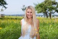 Happy young woman on a summer flower meadow outdoor Royalty Free Stock Photo