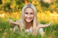 Happy young woman on a summer flower meadow outdoor