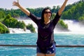 Happy young woman in sunglasses in rhine falls, Switzerland Royalty Free Stock Photo