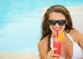 Happy young woman in swimsuit drinking cocktail Royalty Free Stock Photo