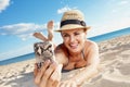 Happy young woman in swimwear taking selfie with phone on beach Royalty Free Stock Photo