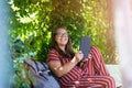 Young woman with tablet computer in the park