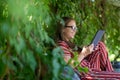 Young woman with tablet computer in the park