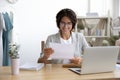 Happy young woman tailor receiving paper letter with good offer