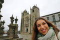 Happy young woman take selfie photo in front of Porto Cathedral in winter time. Self portrait of beautiful girl in Porto, Portugal