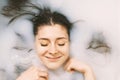 Happy young woman taking a bath in milk Royalty Free Stock Photo