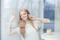 Happy young woman talking on mobile phone in cafe Royalty Free Stock Photo