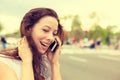 Happy young woman talking on mobile phone walking on a street Royalty Free Stock Photo