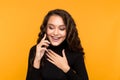 Happy young woman talking phone  over the yellow background. Royalty Free Stock Photo