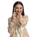 happy young woman talking on the phone and making thumbs up gesture Royalty Free Stock Photo