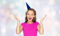 Happy young woman or teen girl in party cap Royalty Free Stock Photo