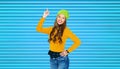 Happy young woman or teen girl pointing finger up Royalty Free Stock Photo