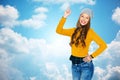 Happy young woman or teen girl pointing finger up Royalty Free Stock Photo