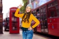Happy young woman or teen girl pointing finger up Royalty Free Stock Photo