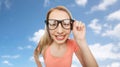 Happy young woman or teenage girl in eyeglasses Royalty Free Stock Photo