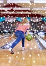 Happy young woman throwing ball in bowling club Royalty Free Stock Photo