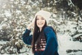 Happy young brunette woman throwing snow ball in winter park Royalty Free Stock Photo