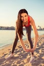 Happy young woman tiping on the beach to be flexible Royalty Free Stock Photo