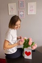 A happy young woman touches a bouquet presented to her. Spring flowers and greeting card Royalty Free Stock Photo