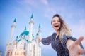 Happy young woman tourist make selfie photo on background of Kul Sharif Mosque Kazan Kremlin. Concept Travel Russia Royalty Free Stock Photo