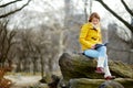 Happy young woman tourist reading a book at Central Park in New York City. Female traveler enjoying views of downtown Manhattan. Royalty Free Stock Photo