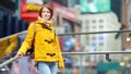 Happy young woman tourist sightseeing at Times Square in New York City. Female traveler enjoying view of downtown Manhattan. Royalty Free Stock Photo