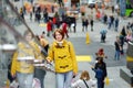 Happy young woman tourist sightseeing at Times Square in New York City. Female traveler enjoying view of downtown Manhattan. Royalty Free Stock Photo