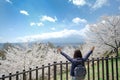 Happy Young Woman traveling with beautiful pink Cherry Blossom and Mount Fuji at Chureito red Pagoda temple area. Spring Season at Royalty Free Stock Photo