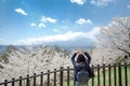 Happy Young Woman traveling with beautiful pink Cherry Blossom and Mount Fuji at Chureito red Pagoda temple area. Spring Season at Royalty Free Stock Photo