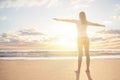 Happy young woman traveller enjoys her summer vacation in a morning sun dawn on a tropical beach resert