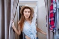 Happy young woman trying on clothes in dressing room Royalty Free Stock Photo