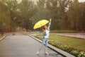 Happy young woman with umbrella under rain Royalty Free Stock Photo