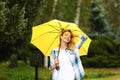 Happy young woman with umbrella under rain Royalty Free Stock Photo