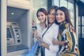 Happy young woman using cash machine. Women using credit card. L