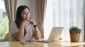 Happy young woman using computer laptop, surfing internet, reading news, shopping online at home Royalty Free Stock Photo