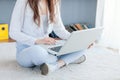 Happy young woman using laptop at home Royalty Free Stock Photo