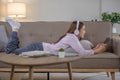 Happy young woman using laptop at home sitting on soft couch. Lady is working on laptop computer. Girl student is typing Royalty Free Stock Photo