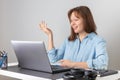 Happy young woman using laptop, watching webinar, studying online, looking at pc screen learning web classes or having virtual Royalty Free Stock Photo