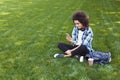 Happy young woman using smartphone in park Royalty Free Stock Photo