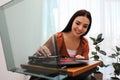 Happy woman using turntable at home