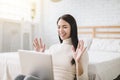 Happy young woman using  video call by laptop and  lying on the bed Royalty Free Stock Photo