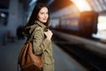 Happy young woman waitng train on the railway station platform. Woman travel with the train. Royalty Free Stock Photo