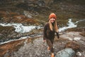 Happy young woman walking alone in scandinavian mountains
