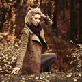 Happy young blond fashion woman walking in autumn city park Royalty Free Stock Photo