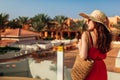 Young woman walking on hotel territory. Summer vacation in Egypt. Stylish fashionable look Royalty Free Stock Photo