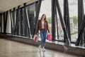 Happy young woman walking on the street with colorful shopping bags. Royalty Free Stock Photo