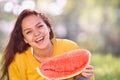 Happy young woman with watermelon in the park. Royalty Free Stock Photo